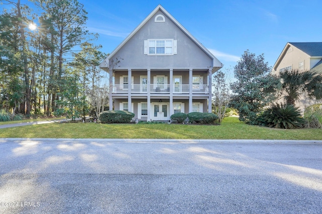 view of front of property with a front lawn and a balcony