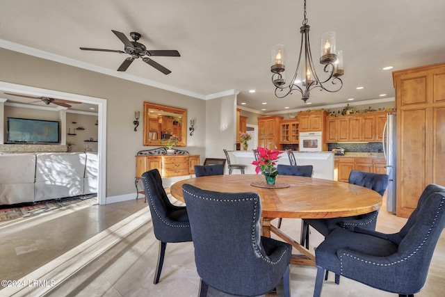 dining space with crown molding and ceiling fan with notable chandelier