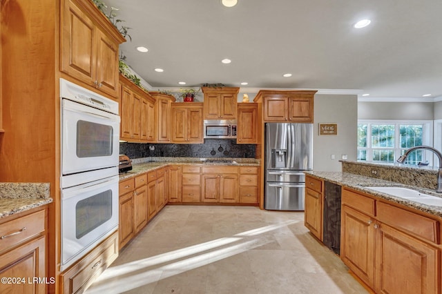 kitchen featuring sink, stainless steel appliances, tasteful backsplash, light stone countertops, and light tile patterned flooring