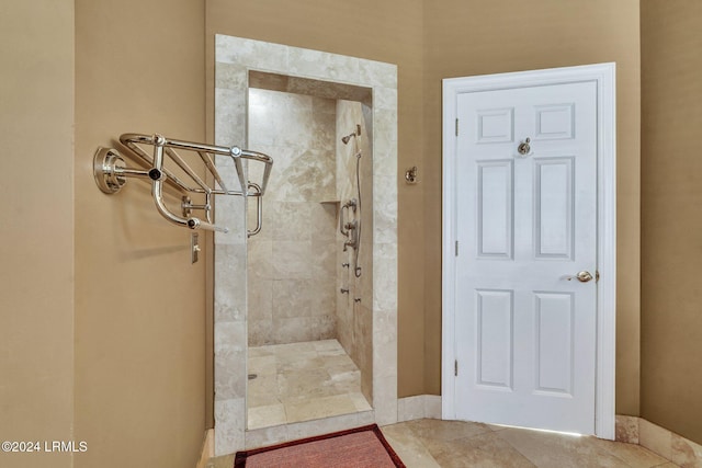 bathroom with tiled shower and tile patterned floors