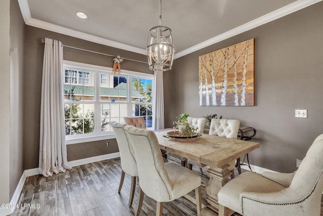 dining room featuring a notable chandelier, crown molding, and wood-type flooring