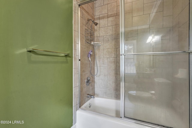 bathroom featuring combined bath / shower with glass door