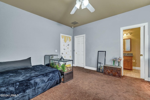 carpeted bedroom featuring ensuite bath and ceiling fan