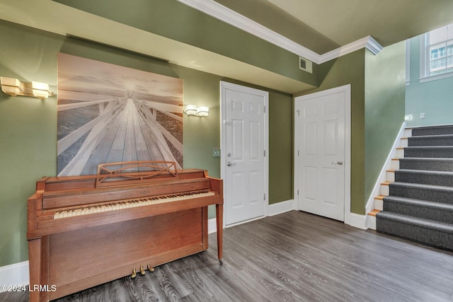 miscellaneous room with hardwood / wood-style flooring and ornamental molding