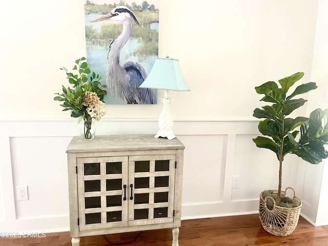 details featuring a decorative wall and wood finished floors