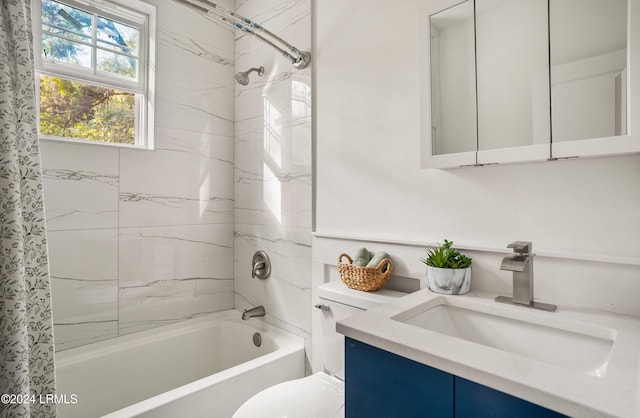 full bathroom featuring toilet, shower / bath combination with curtain, and vanity