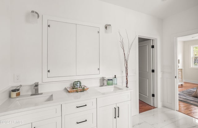 bathroom featuring a sink and double vanity