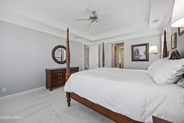 carpeted bedroom with a raised ceiling, crown molding, and ceiling fan