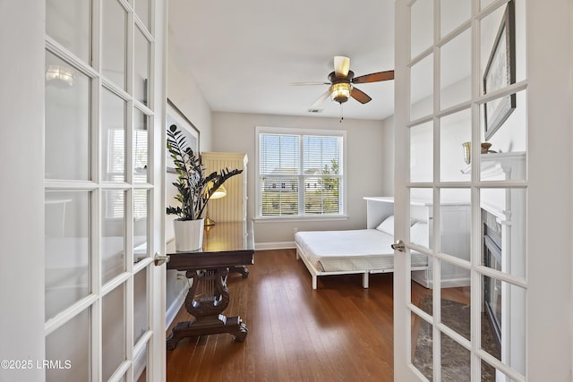 interior space featuring dark hardwood / wood-style floors, ceiling fan, and french doors