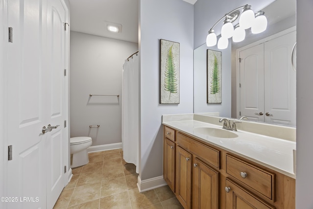bathroom featuring tile patterned floors, vanity, and toilet