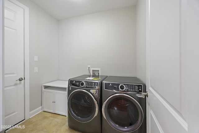 laundry area featuring cabinets and washer and dryer