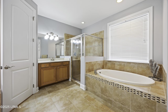 bathroom with shower with separate bathtub and vanity