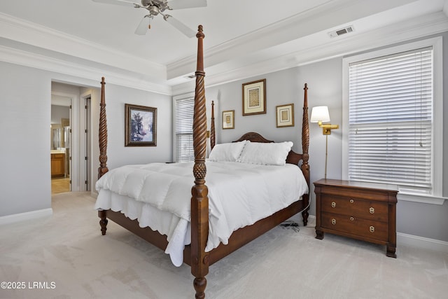 bedroom with crown molding, light colored carpet, and a raised ceiling