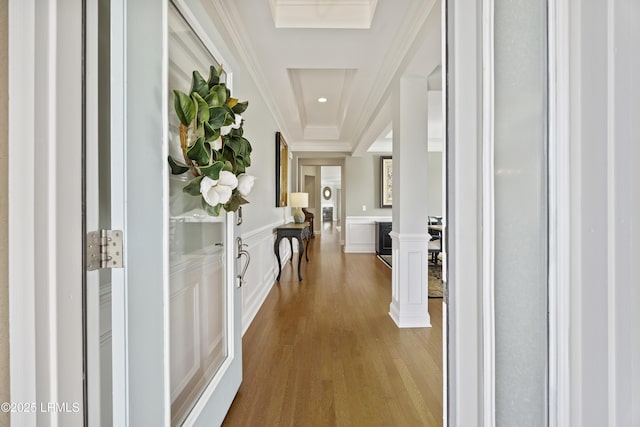 corridor with hardwood / wood-style flooring and ornamental molding