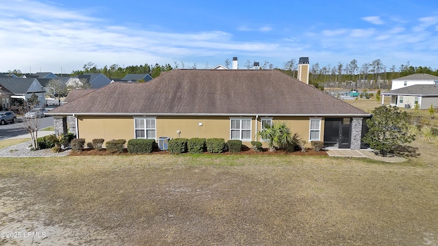 back of property featuring a yard
