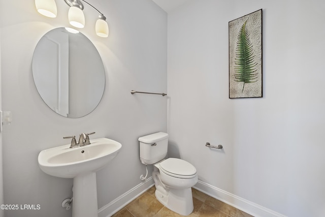 bathroom with sink, tile patterned floors, and toilet
