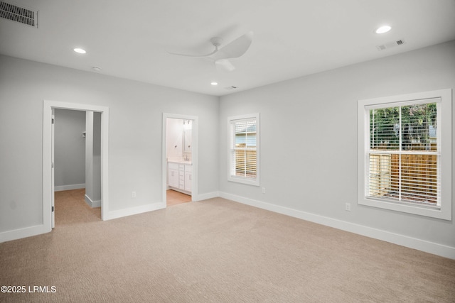 12 Meagan Dr, Beaufort, SC 29907 - unfurnished bedroom featuring light colored carpet, baseboards, recessed lighting, a spacious closet, and ensuite bath