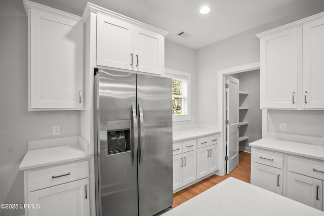 12 Meagan Dr, Beaufort, SC 29907 - kitchen with stainless steel refrigerator with ice dispenser, light wood finished floors, white cabinets, and recessed lighting