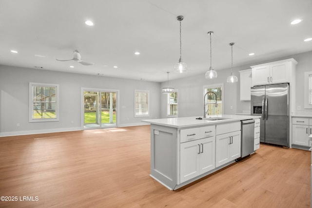 12 Meagan Dr, Beaufort, SC 29907 - kitchen featuring stainless steel appliances, a sink, light wood-style floors, recessed lighting, and light countertops