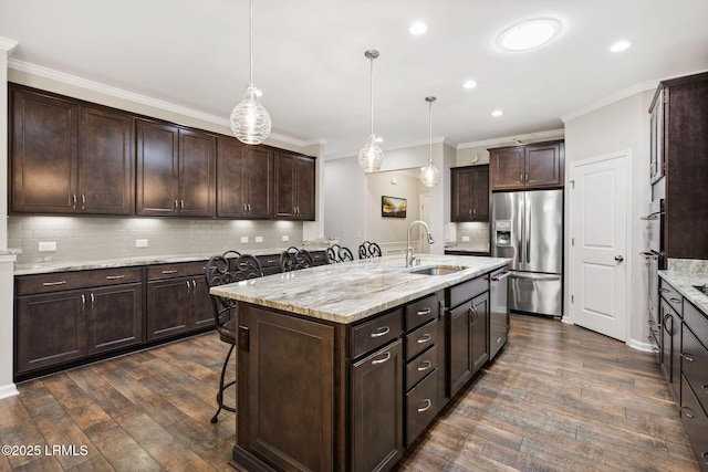 21 Heathrow Ave, Bluffton, SC 29910 - kitchen with stainless steel appliances, dark wood-style flooring, dark brown cabinetry, ornamental molding, and backsplash