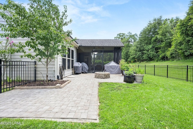 21 Heathrow Ave, Bluffton, SC 29910 - fenced backyard featuring a sunroom, a patio, and a fire pit