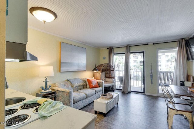 living room with ornamental molding and wood finished floors