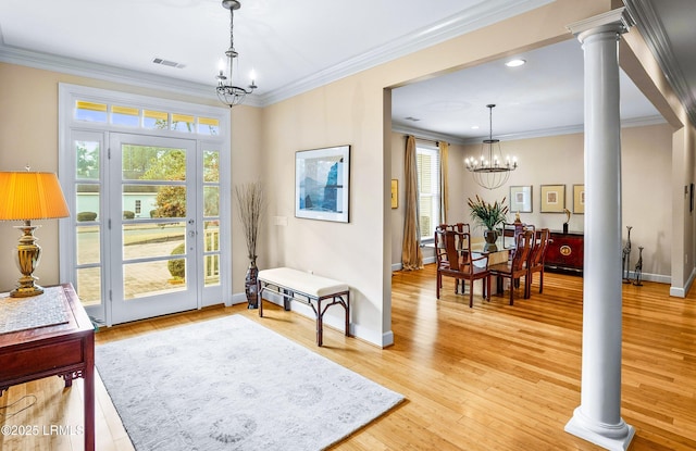 sitting room with ornamental molding, a chandelier, decorative columns, and hardwood / wood-style floors