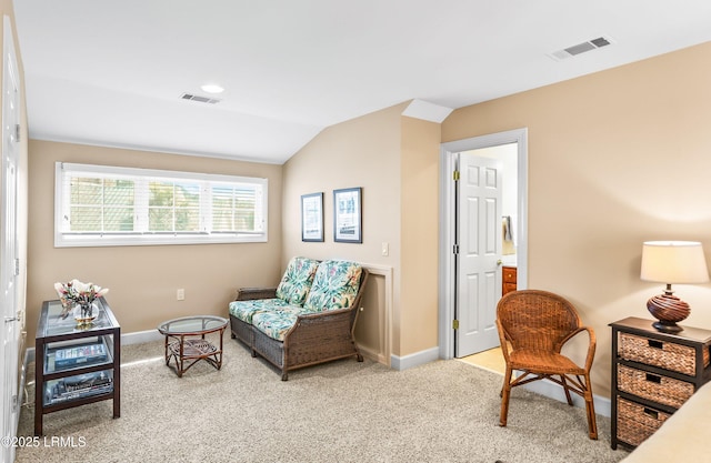 living area with vaulted ceiling and light colored carpet