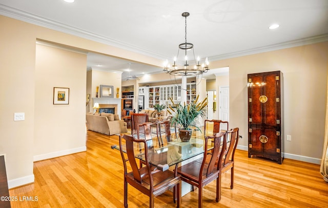 dining room featuring crown molding, a notable chandelier, and light hardwood / wood-style flooring