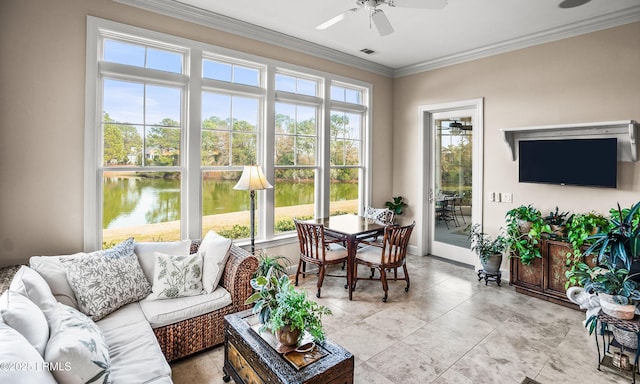 sunroom with a water view and ceiling fan