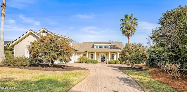 view of front facade with a front yard and covered porch