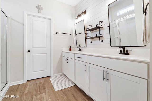 bathroom featuring vanity, hardwood / wood-style floors, and an enclosed shower