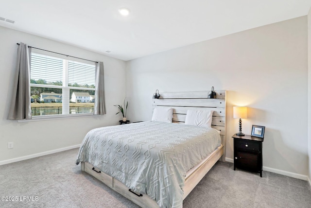 bedroom featuring light colored carpet