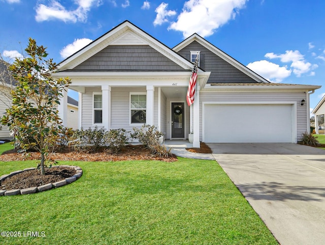 view of front facade with a garage, a front yard, and covered porch