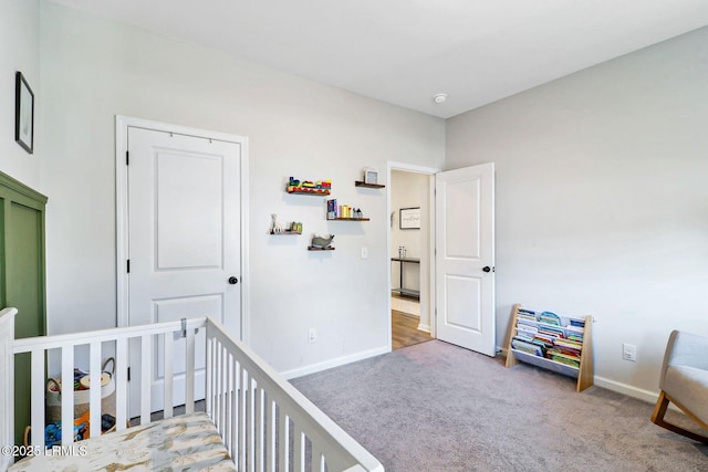 bedroom with carpet flooring and a crib