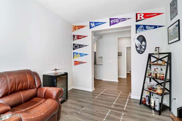 sitting room with dark hardwood / wood-style floors and wine cooler