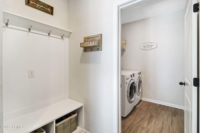 clothes washing area featuring separate washer and dryer and hardwood / wood-style floors