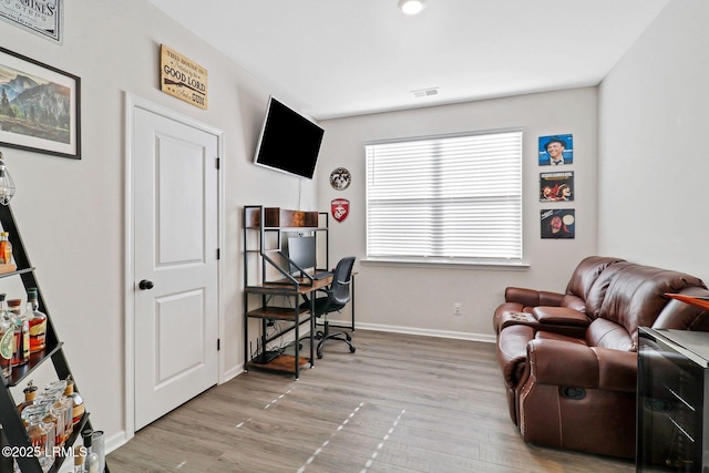 office with light wood-type flooring