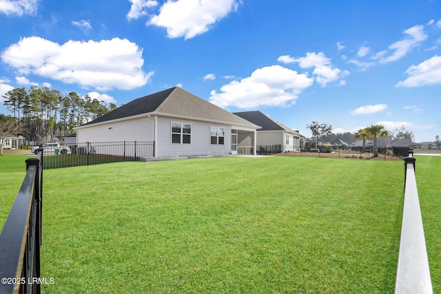 rear view of property featuring a lawn