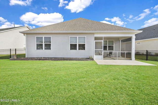 back of house featuring a yard, a patio area, and a sunroom