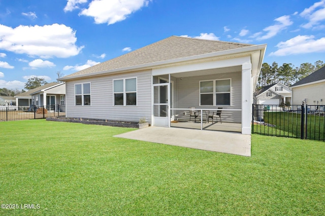 rear view of house with a lawn and a patio area