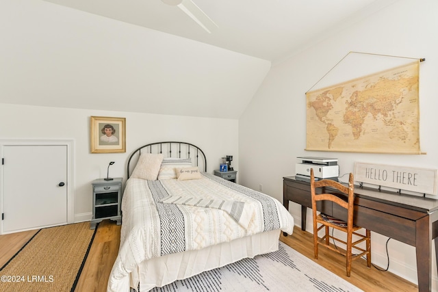 bedroom featuring vaulted ceiling and light hardwood / wood-style floors