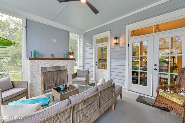 sunroom with a healthy amount of sunlight, ceiling fan, and french doors