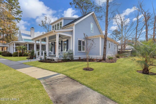 entrance to property with covered porch and ceiling fan