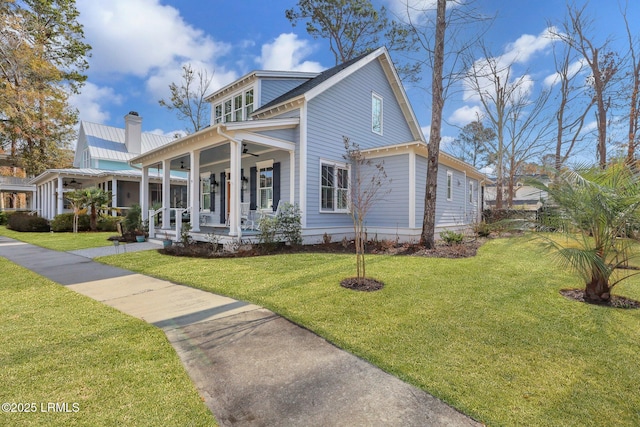 view of front of property with a front yard and covered porch