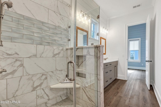 bathroom featuring crown molding, vanity, an enclosed shower, and wood-type flooring