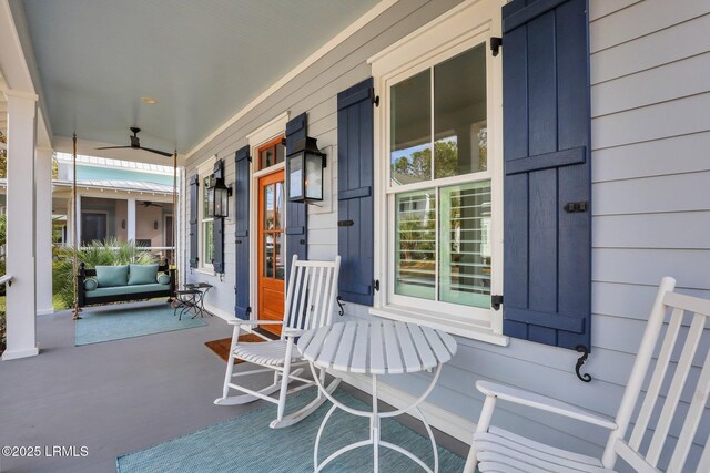 entryway with light wood-type flooring, ornamental molding, and ornate columns