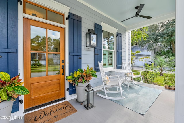 property entrance featuring ceiling fan and a porch