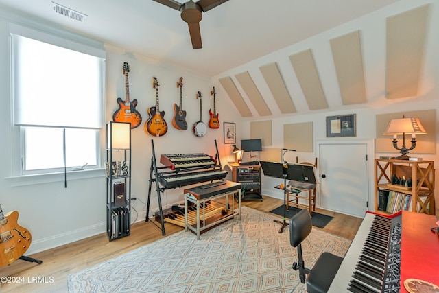 miscellaneous room with lofted ceiling and light hardwood / wood-style floors