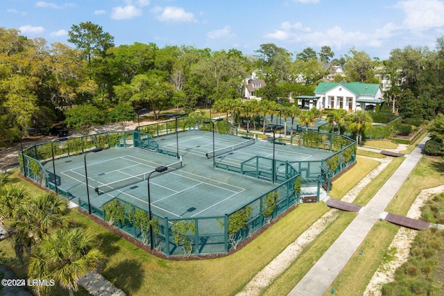 view of sport court with a lawn